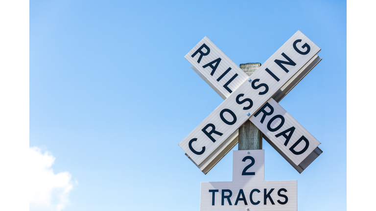 Railroad crossing sign against clear blue sky. Seattle, Washington, USA.