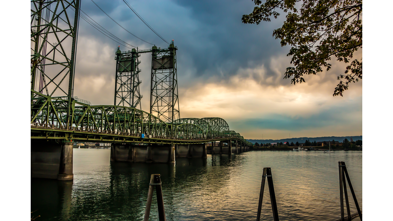 Colorful Sunset Over Columbia River Oregon Washington Bridge Dense Clouds
