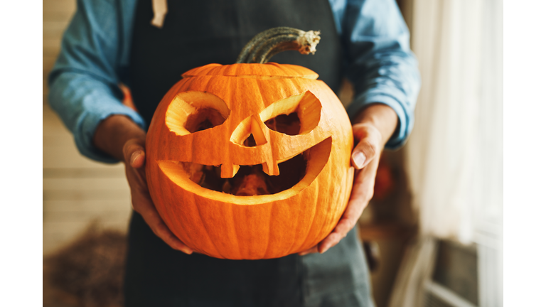 man in apron with Halloween pumpkin monster spooky jack-o-lanter