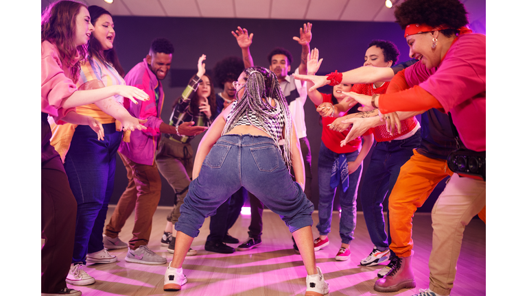 Group of people cheering their twerking friend