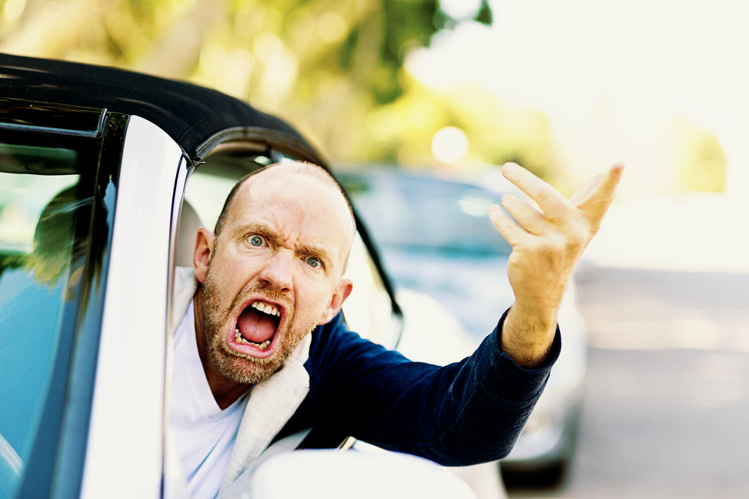 Enraged male driver shouts and gestures threateningly
