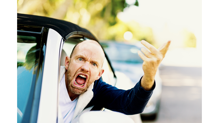 Enraged male driver shouts and gestures threateningly