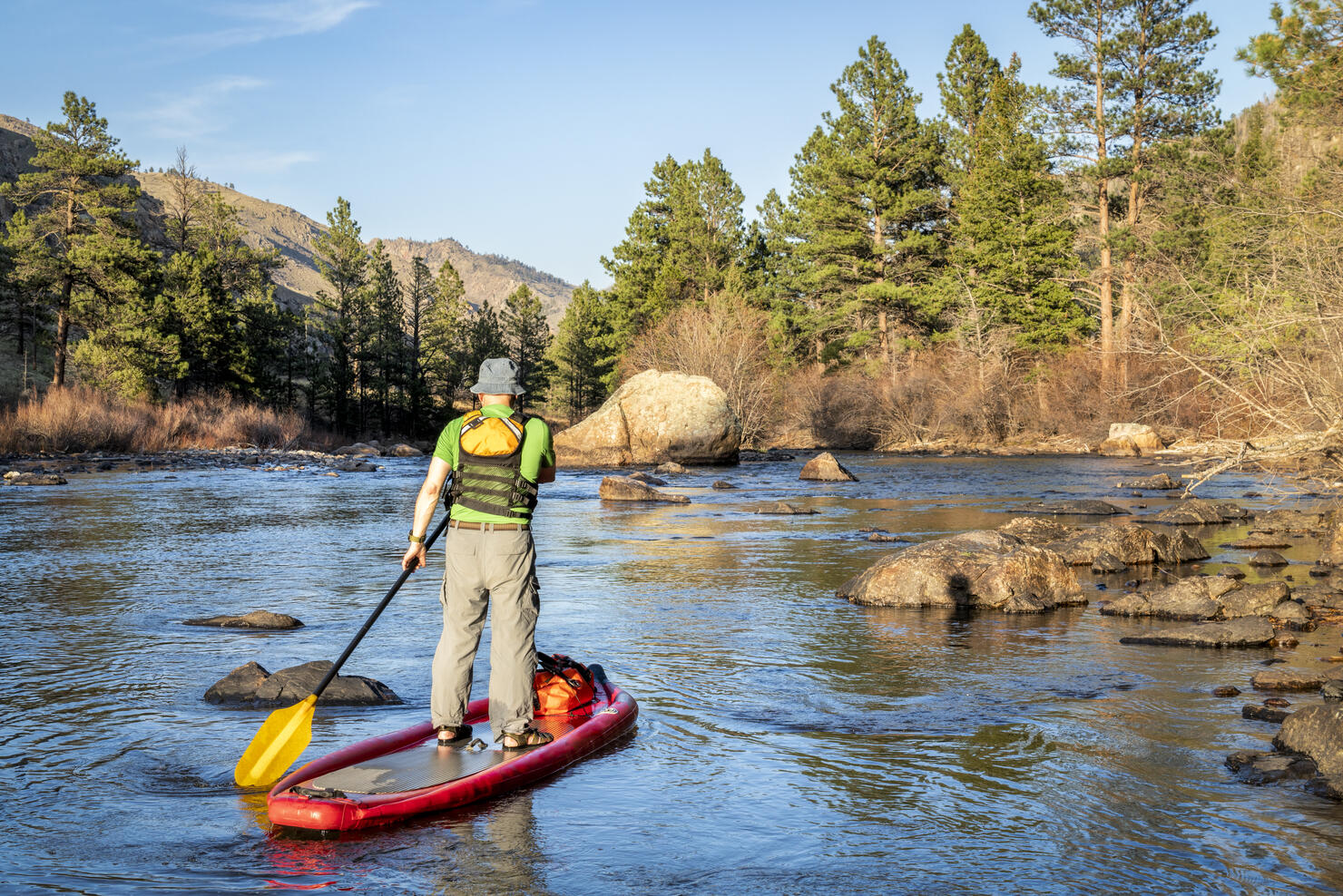 stand up paddling on mountain river