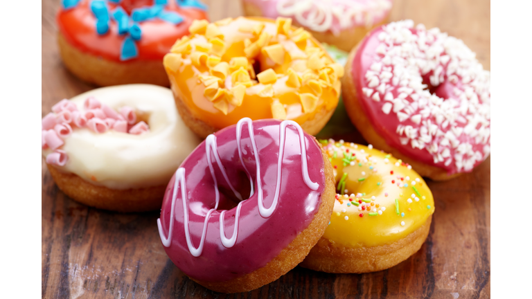 Close-up of colorful donuts on wooden table