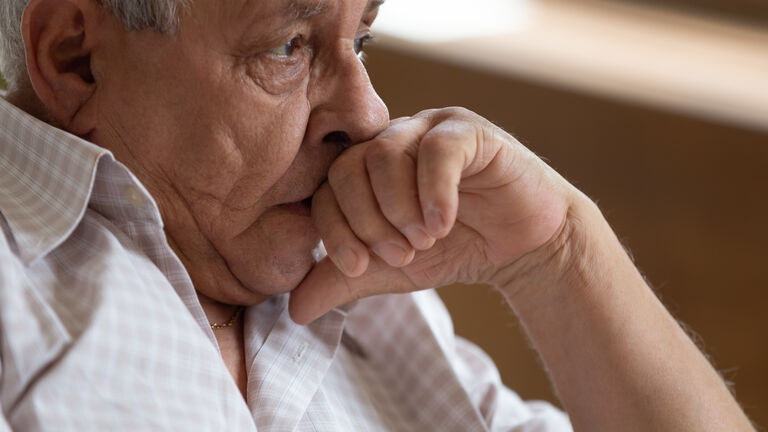 Sad elderly male look in distance mourning