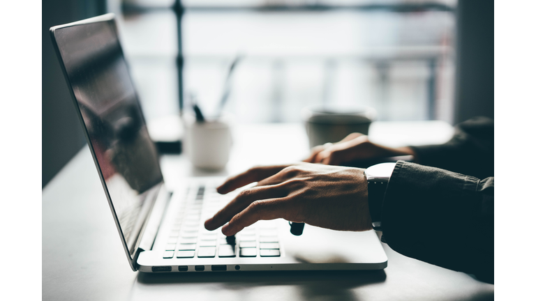 Man working online at home on his laptop computer.