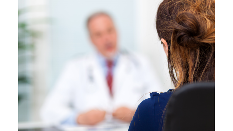 Doctor talking to a patient in his office