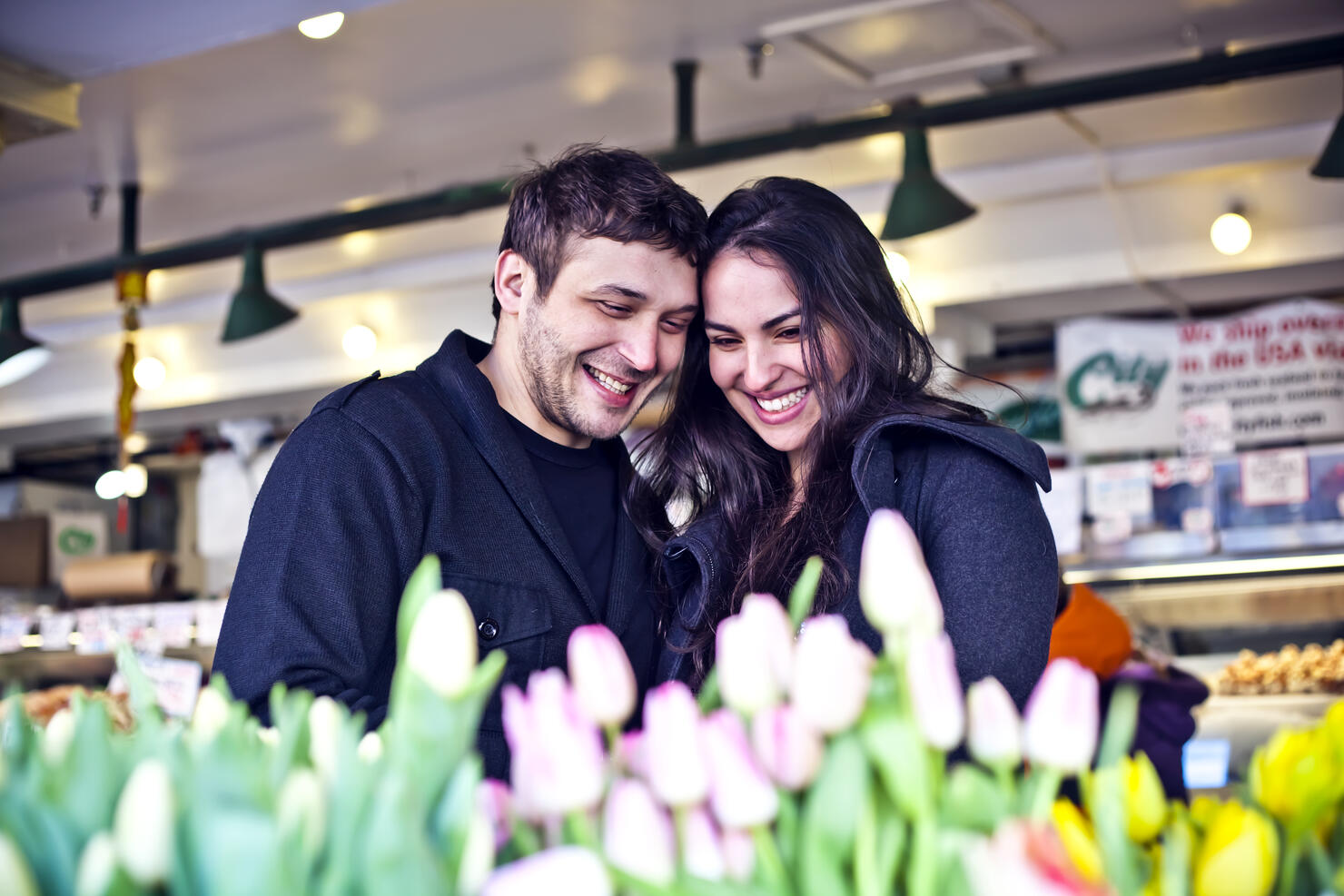 Couple buying flowers at market