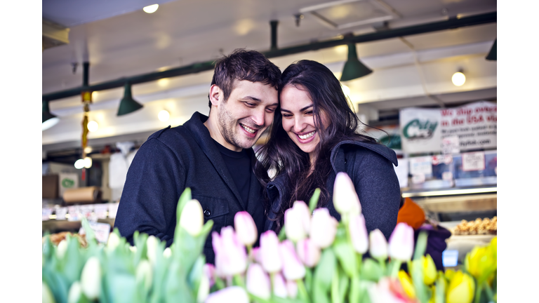 Couple buying flowers at market