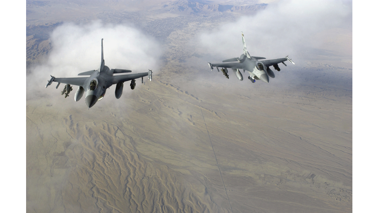 A pair of US Air Force F-16C Fighting Falcons, 174th Fighter Wing (FW), New York Air National Guard (NYANG), Syracuse, New York (NY), in flight over Afghanistan in support of Operation Enduring Freedom.