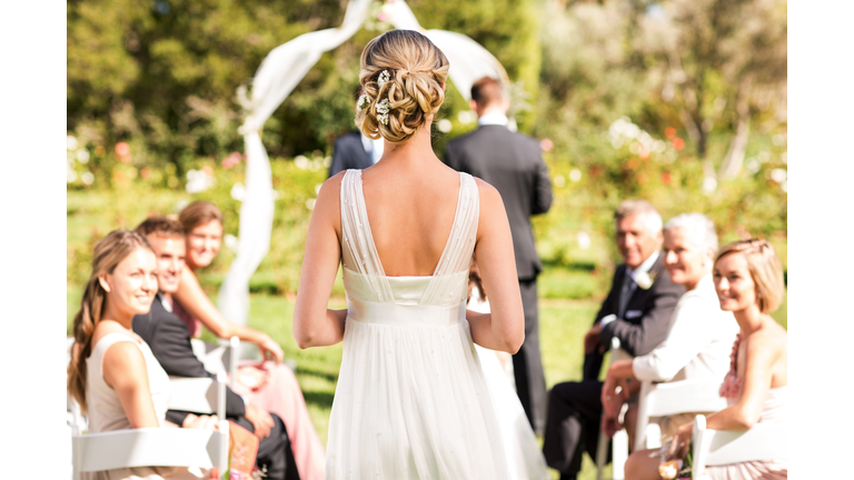 Bride Walking Down The Aisle During Wedding Ceremony