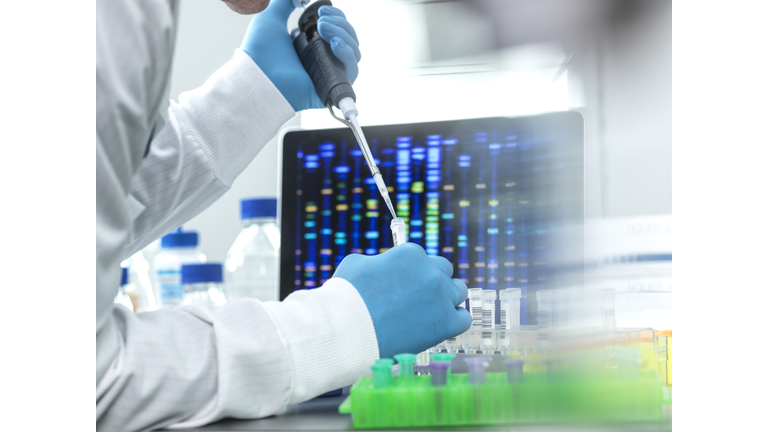 Scientist pipetting sample into a vial for DNA testing