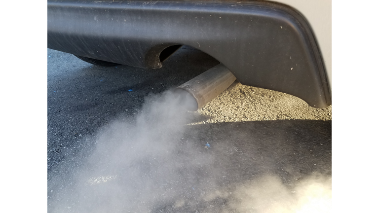 car exhaust or smoke and black asphalt