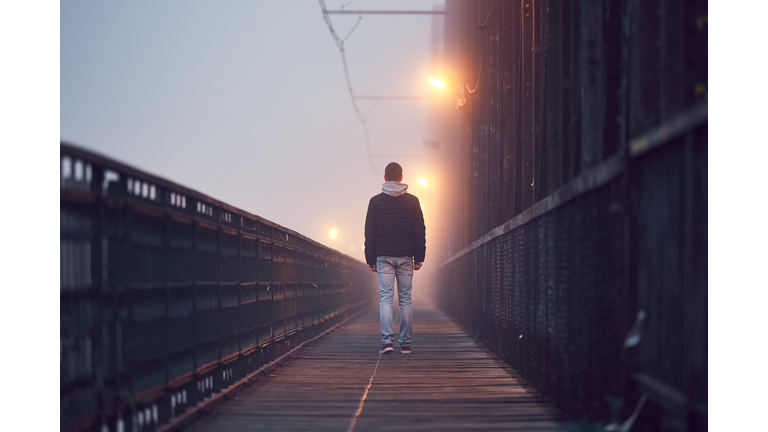 Lonely man on the old bridge