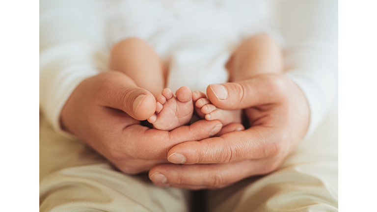 Father with a newborn baby beautiful photos of a young adult man holding little son, paternity leave