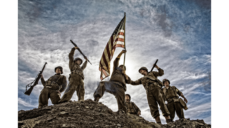 US Army Soldiers on hill with American Flag