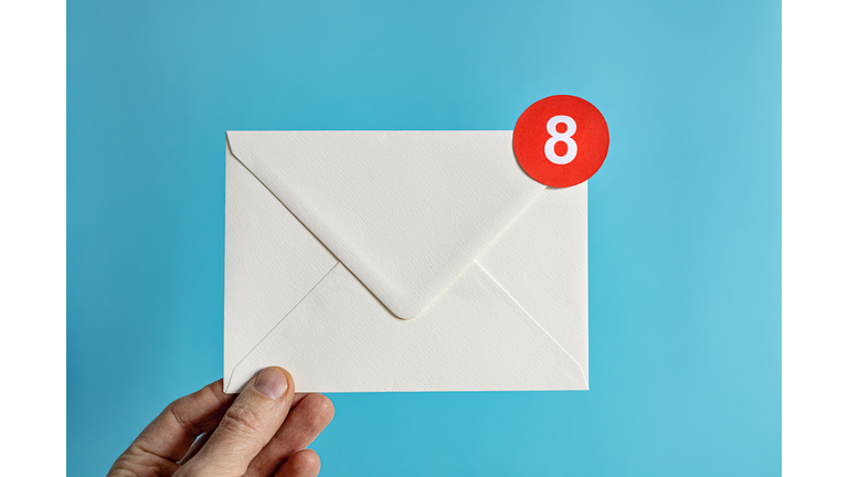 Hand holding white envelope with notification-Email concept