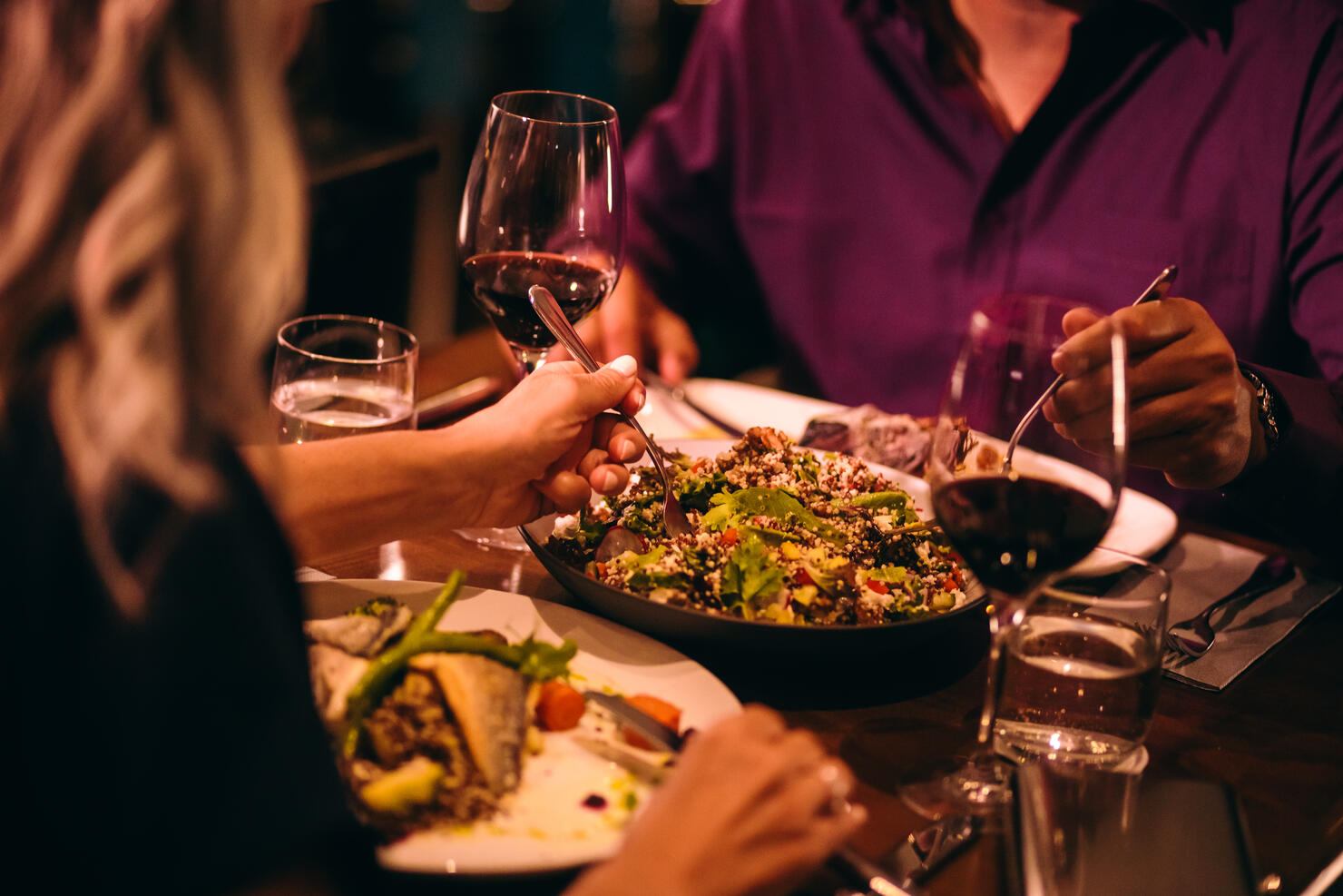 Couple eating quinoa salad and healthy dinner at restaurant