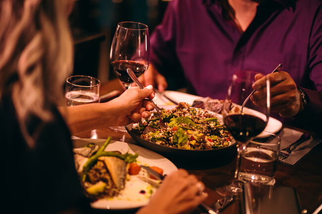 Couple eating quinoa salad and healthy dinner at restaurant