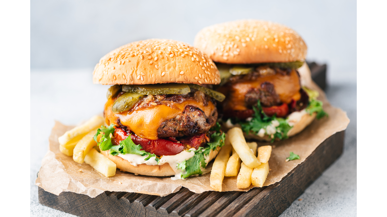 Delicious Juicy Cheeseburgers Served With French Fries