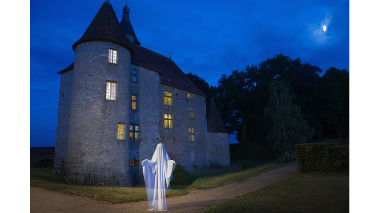 Ghost floating outside stone house