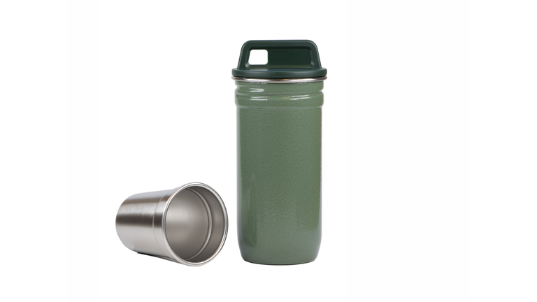 Steel shot glass and flask isolated on white background.