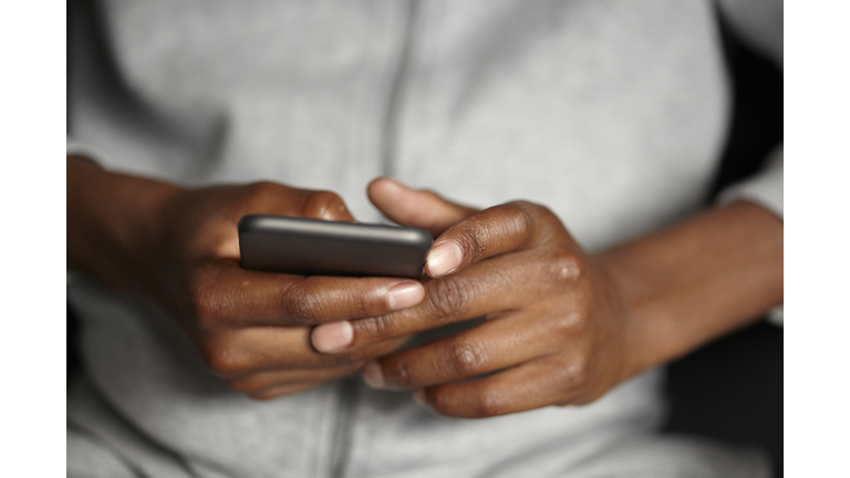 Young Afro Caribbean Teenager Using A mobile Phone