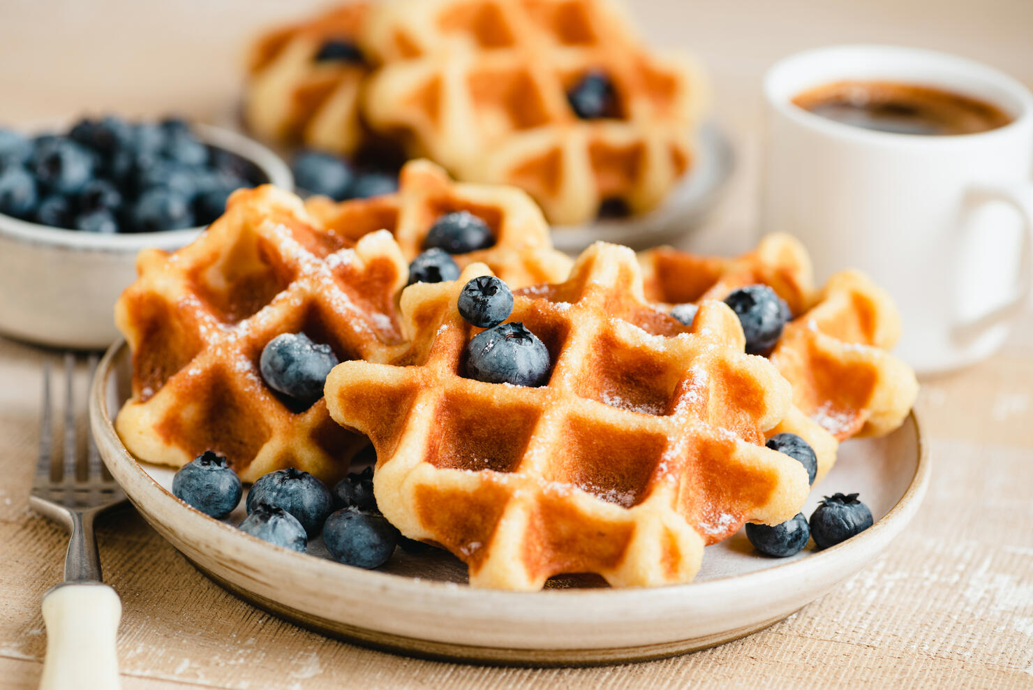 Belgian waffles with blueberries and cup of coffee