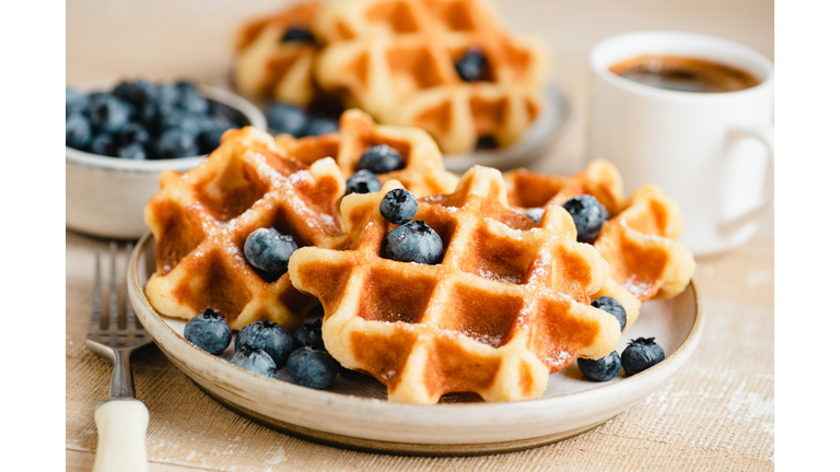 Belgian waffles with blueberries and cup of coffee