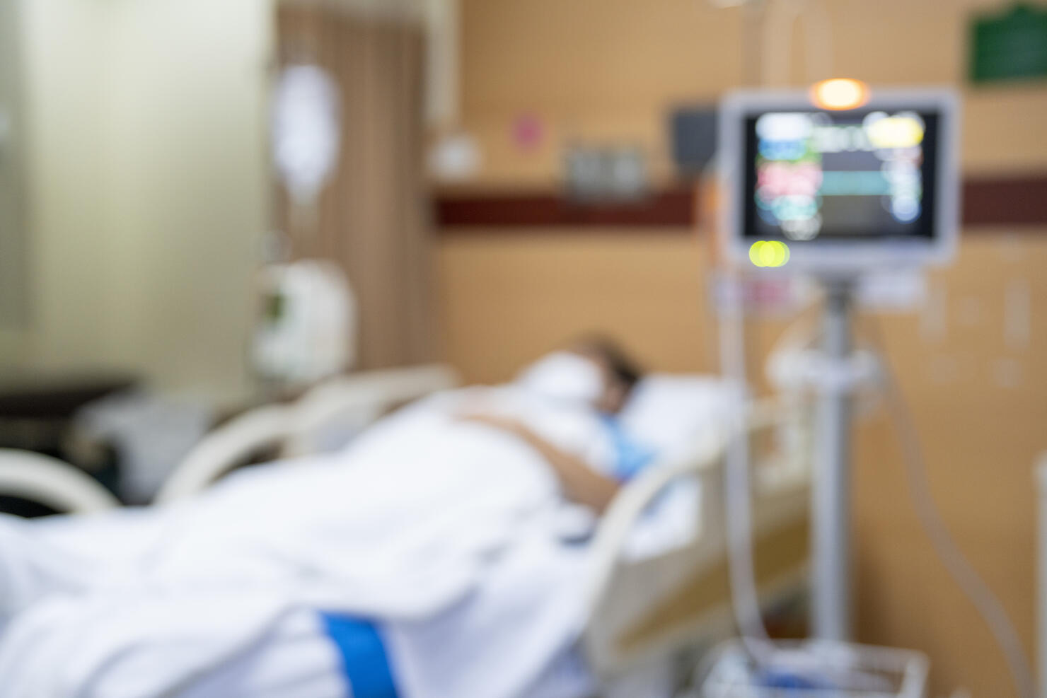 Patient on hospital bed, medical blur interior background white room ward with nursing care or healthcare recovery treatment