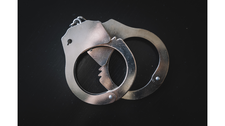 concept of arrest and crime. metal handcuffs on a black table background