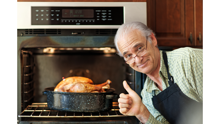 Single senior man cooking turkey