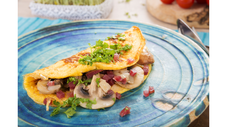 Omelette with champignon, onion and ham on plate