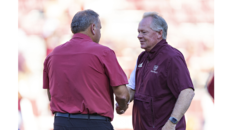 Bobby Petrino shaking hands with Sam Pittman