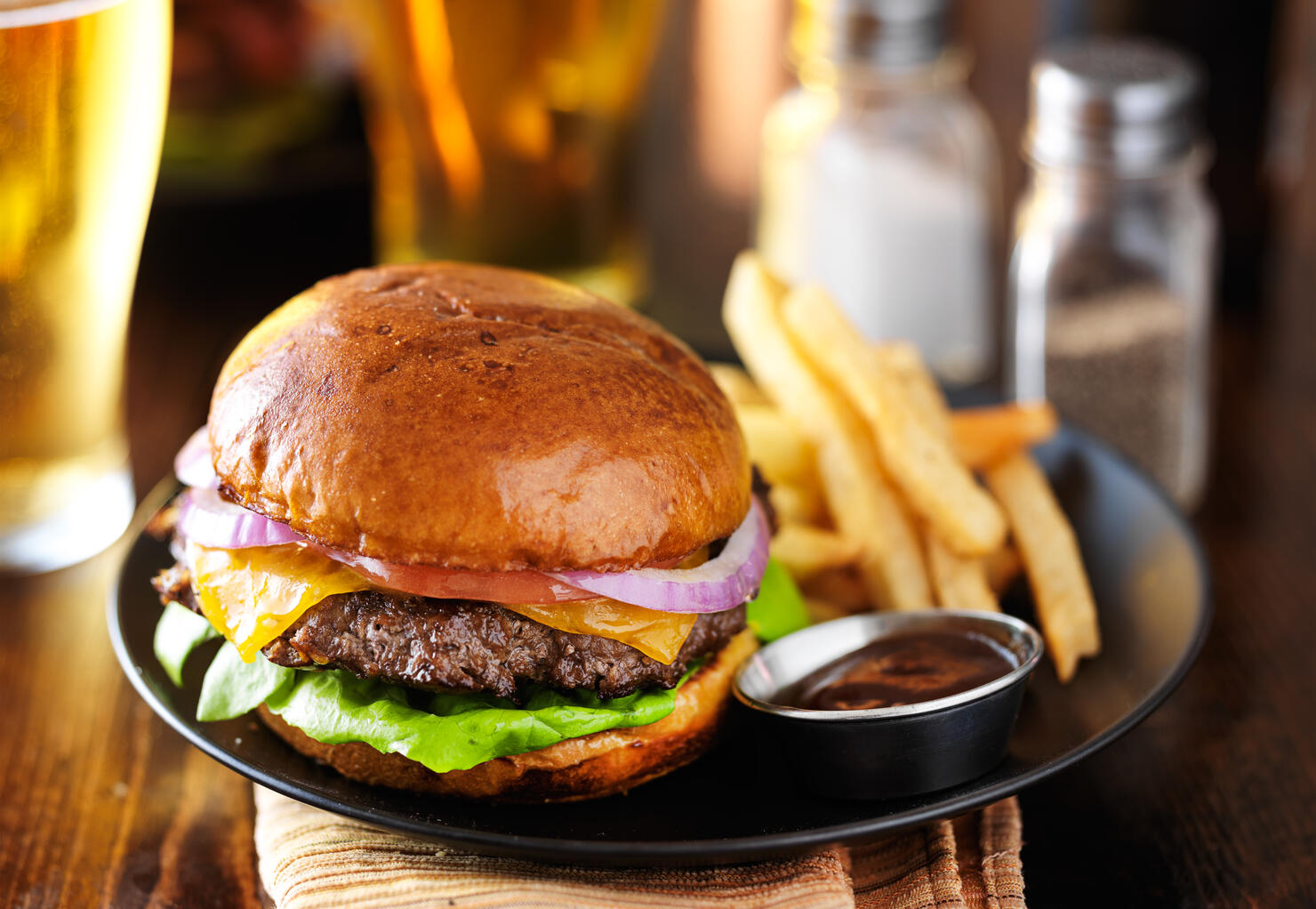 cheeseburger and fries on restaurant table