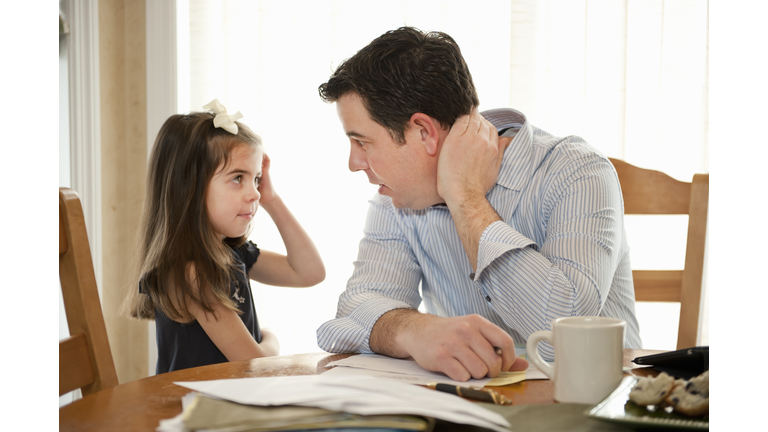 Father talking to Daughter While Working