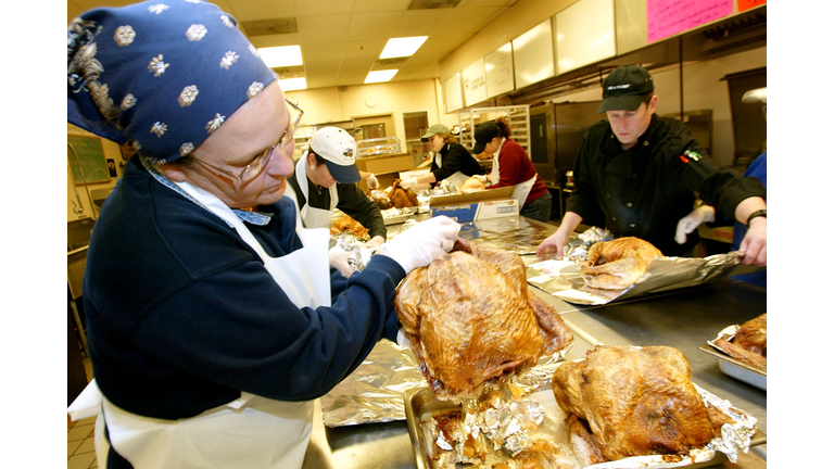 Volunteers help prepare turkey dinners for people