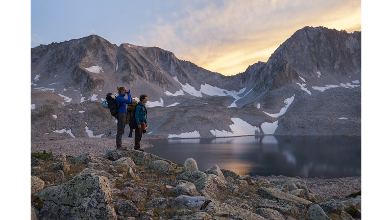 Women hikers watch sunset from Pierre Lakes, Elk Mountains, Colorado