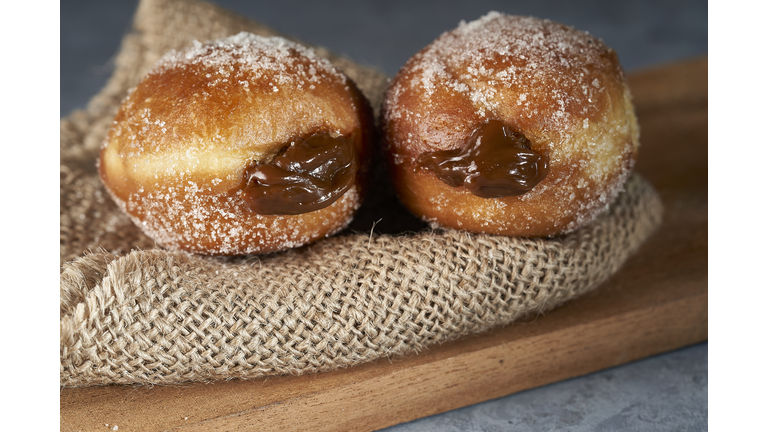 Berliners (berlin balls) stuffed with dulce de leche with sugar on top