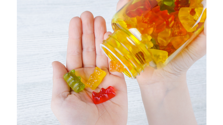 child holds vitamins for kids like jelly candy