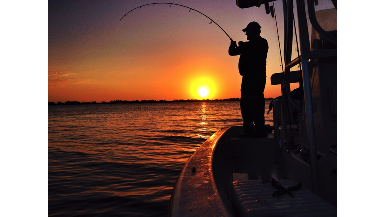 Man Fishing At Sunset