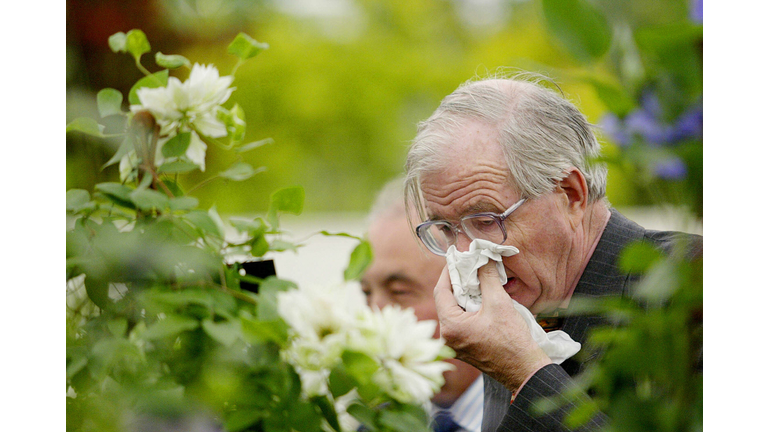 A man covers his face while sneezing nea