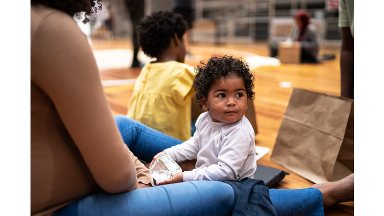 Baby boy with mother in a refugee sheltering