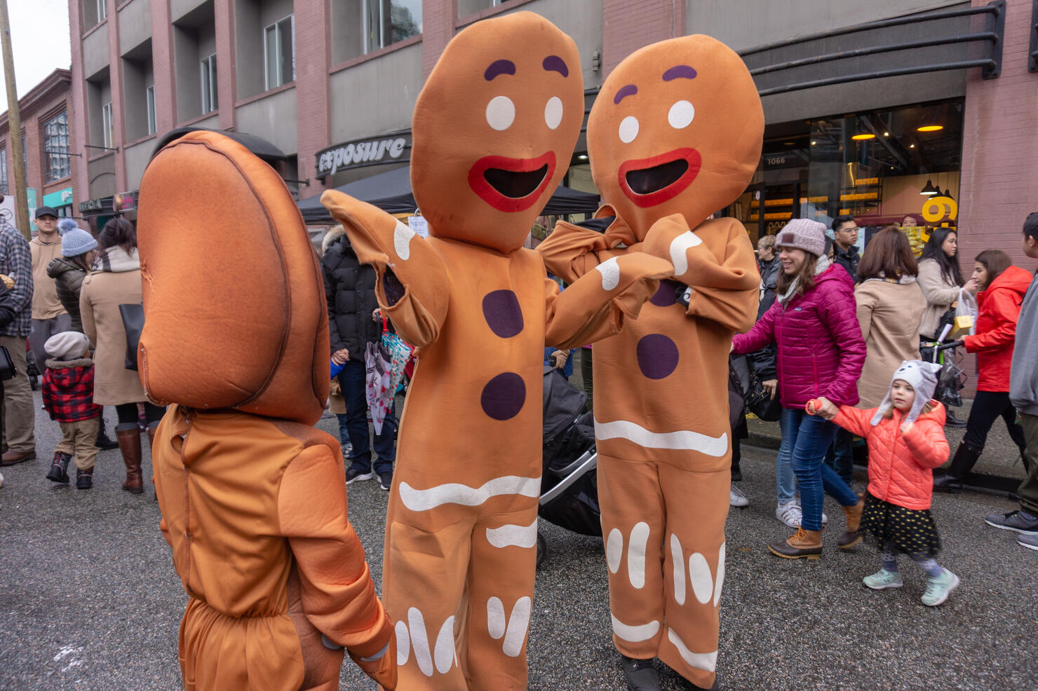 Vancouver, BC, Canada - 11/25/18:  Gingerbread costume people dancing and acting on a city street, during Yaletown CandyTown in Vancouver, B.C., at Christmas time.