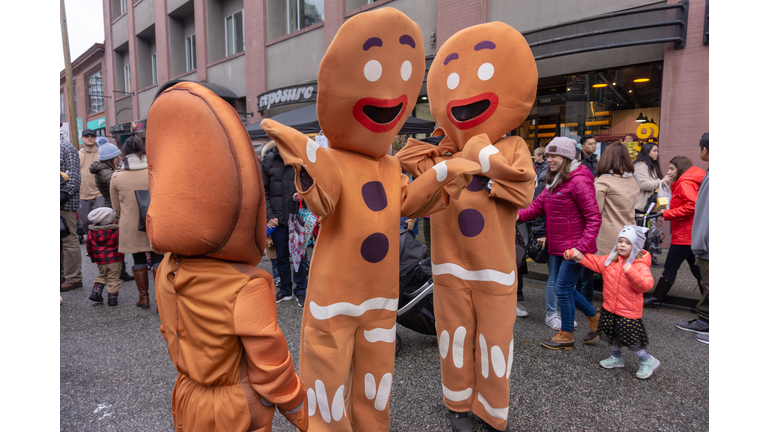Vancouver, BC, Canada - 11/25/18:  Gingerbread costume people dancing and acting on a city street, during Yaletown CandyTown in Vancouver, B.C., at Christmas time.