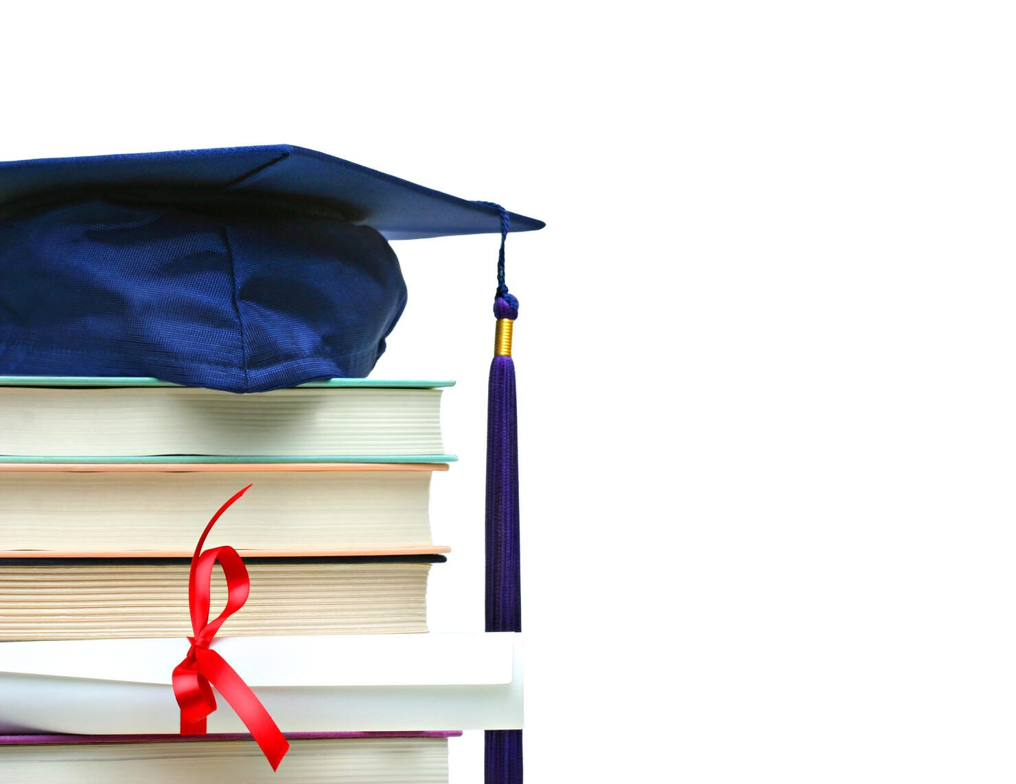 Stack of books with cap and diploma on white,Romania