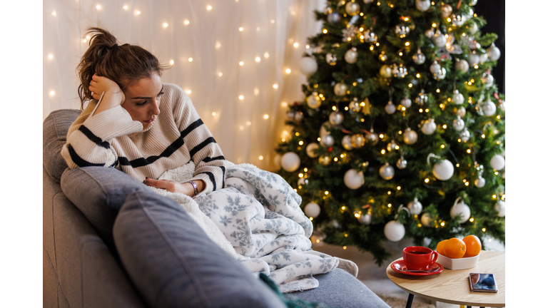 Sad young woman contemplating about Christmas holidays