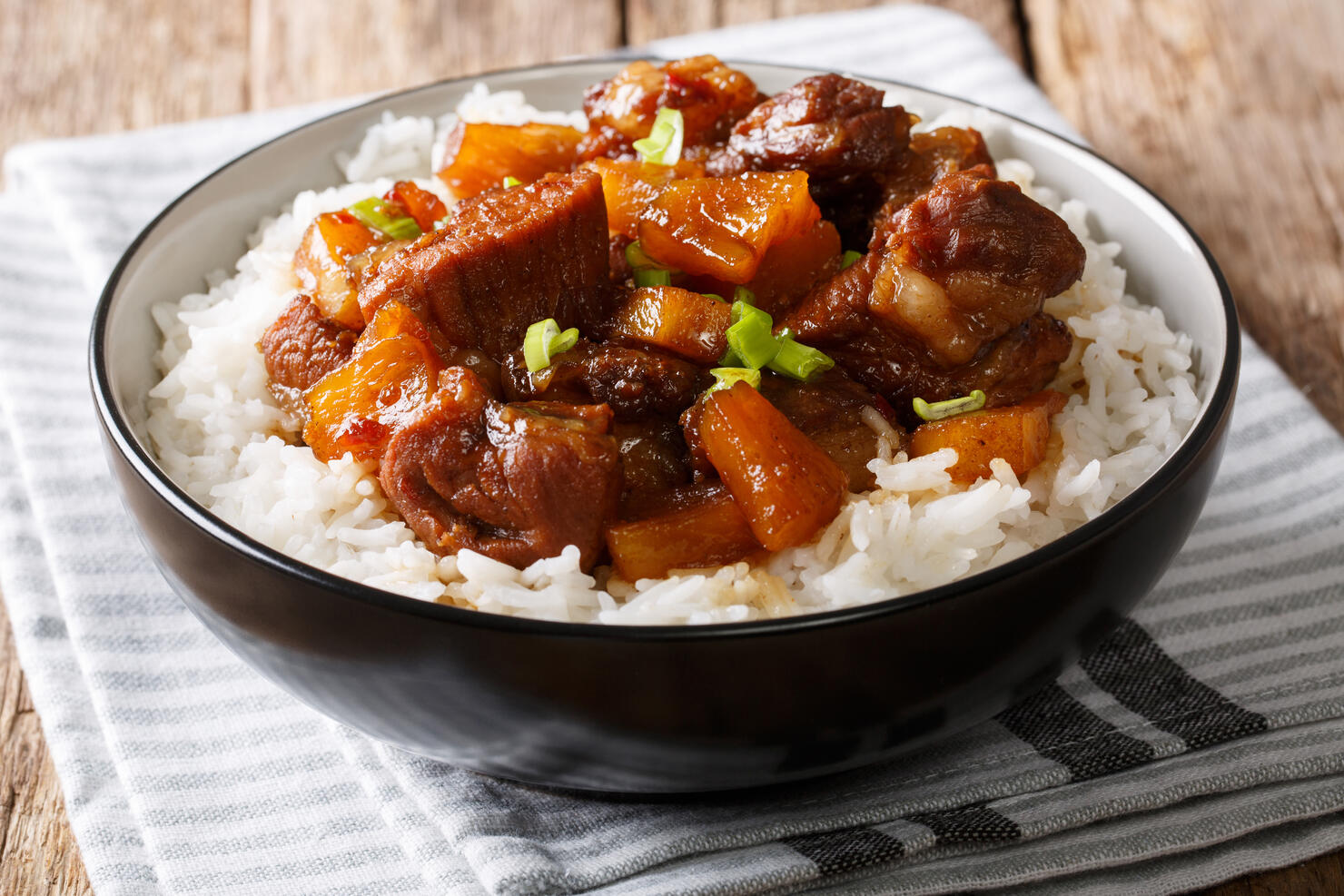 Filipino food: belly pork hamonado with pineapple and rice close-up in a bowl. horizontal