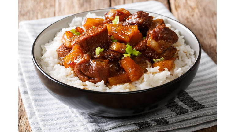 Filipino food: belly pork hamonado with pineapple and rice close-up in a bowl. horizontal