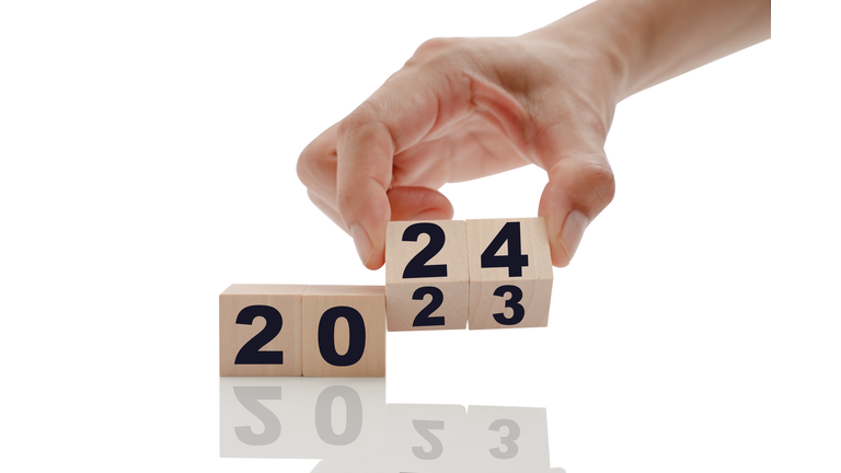 Hand changing Wooden Blocks with 2023 to 2024 year.